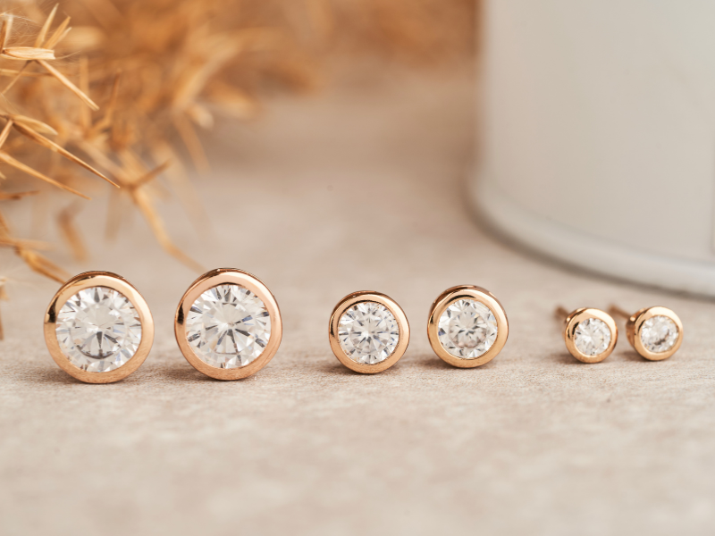 bezel set diamond stud earrings in yellow gold